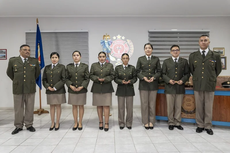 Grupo uniformado posando en una ceremonia de aniversario